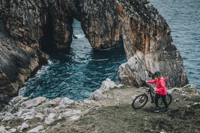 Female bicyclist on rocks