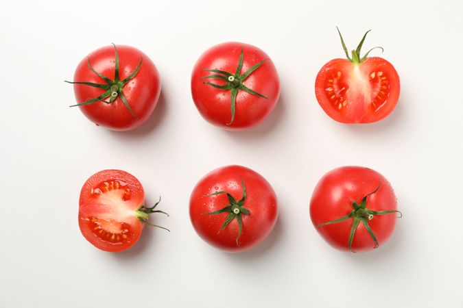 Flat lay with ripe tomatoes on neutral background, top view