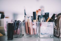 Make up, brushes and lipsticks on the counter