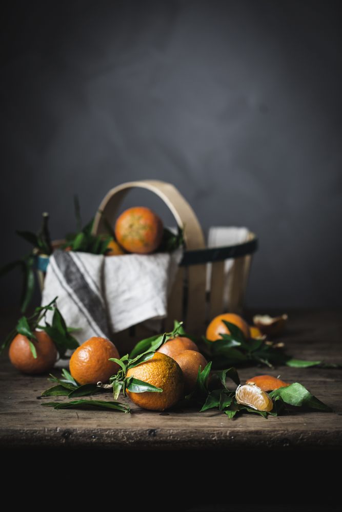 Mandarins and basket on table