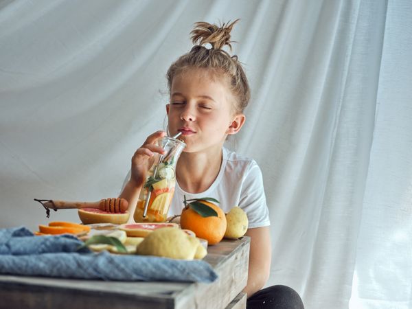 Boy drinking water with fruits