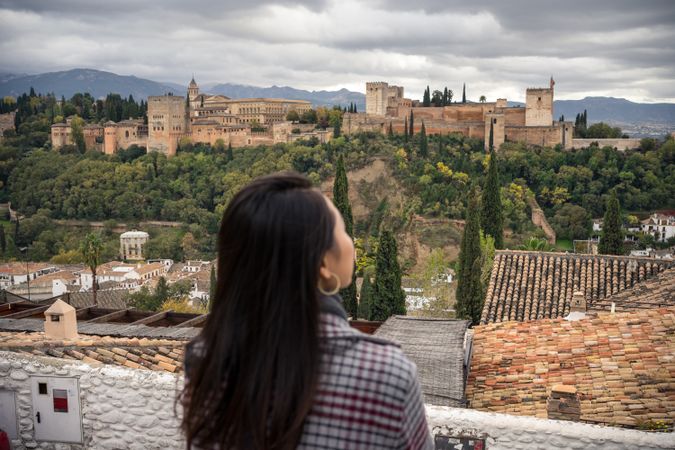 Content female enjoying view of big ancient castle