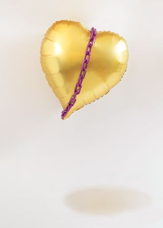 Floating heart balloon with violet purple chains around it
