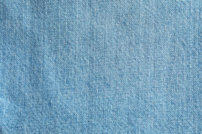 Texture of blue jeans as background, space for text
