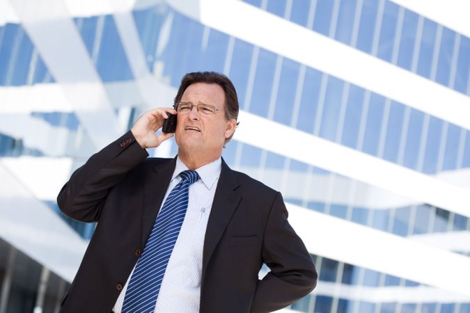 Concerned Businessman Talks on His Cell Phone