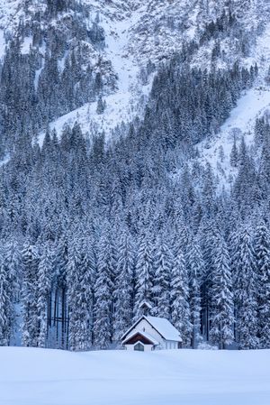 Mountain church in a deep snow nature, winter scenery in the Bavarian Alps, Germany