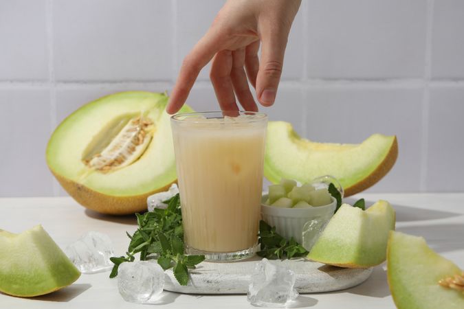 Slices of fresh melon with a glass of juice