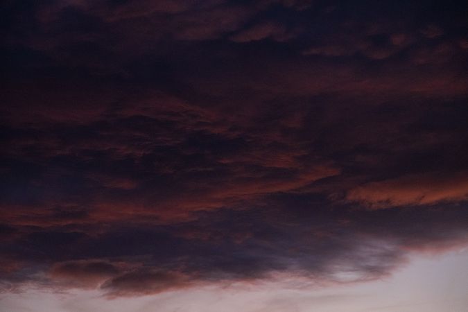 Purple, grey red clouds at dusk