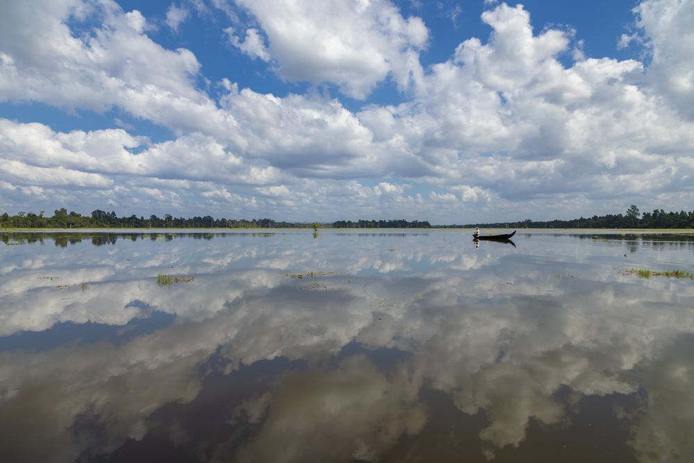 Local fisherman in the lake surrounding the Buddhist Neak Pean temple, near Siem Reap, Cambodia
