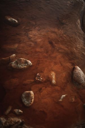 Brown water flowing on rocky ledge