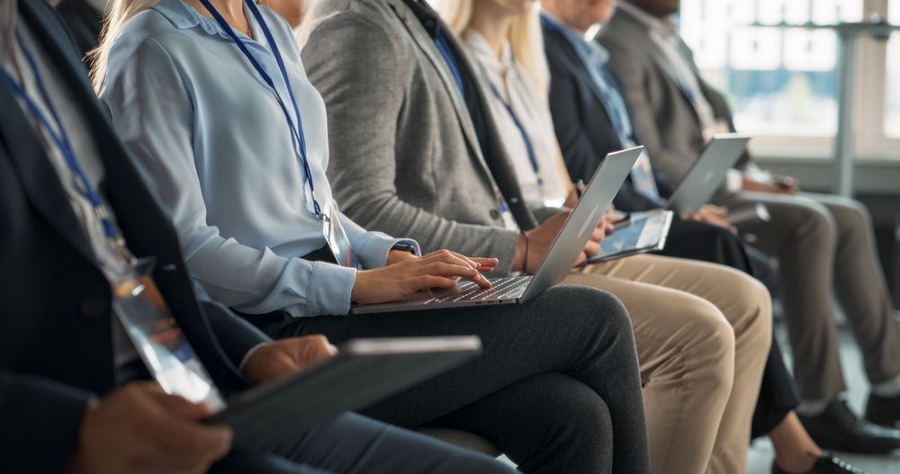 Close Up on Hands: Female Top Manager Sitting in Crowded Auditorium at a Tech Conference.