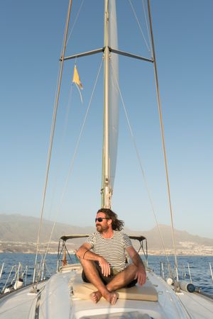 Smiling man on yacht on water