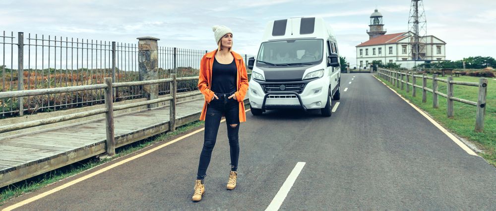 Female walking in front of parked van