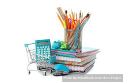 Shopping cart with pile of notebooks, calculator and pencils 5QGRmb