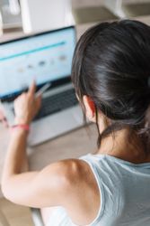 Woman pointing at laptop screen