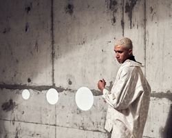 Young man looking down in cement structure