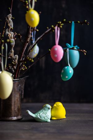 Vase with branches and pastel egg decorations