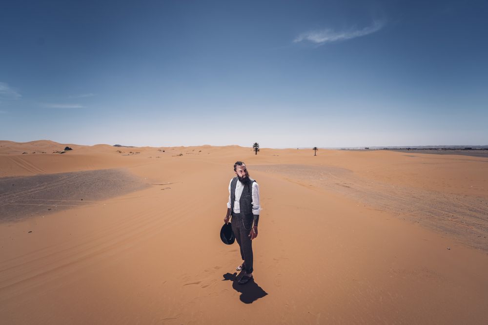 Bearded cowboy in desert