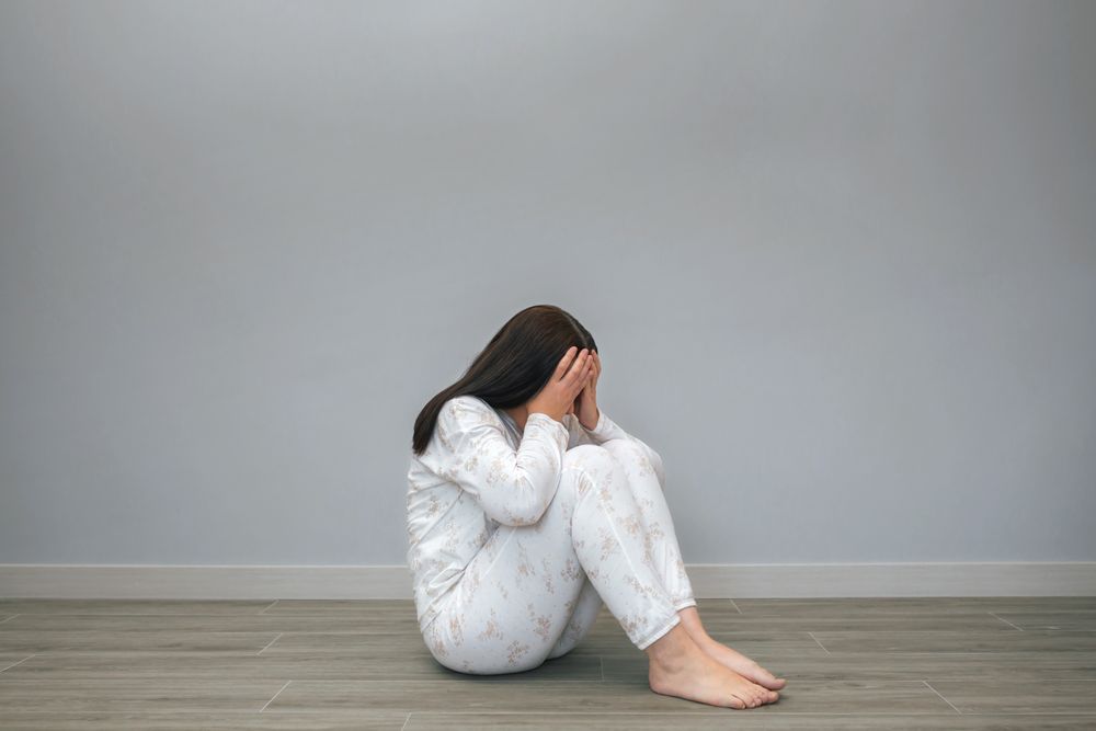 Woman covering her face with hands