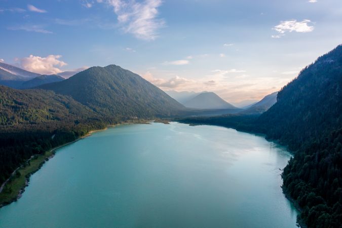 Drone image at sunset with Lake Sylvenstein surrounded by mountains in the Upper Bavaria region, Germany