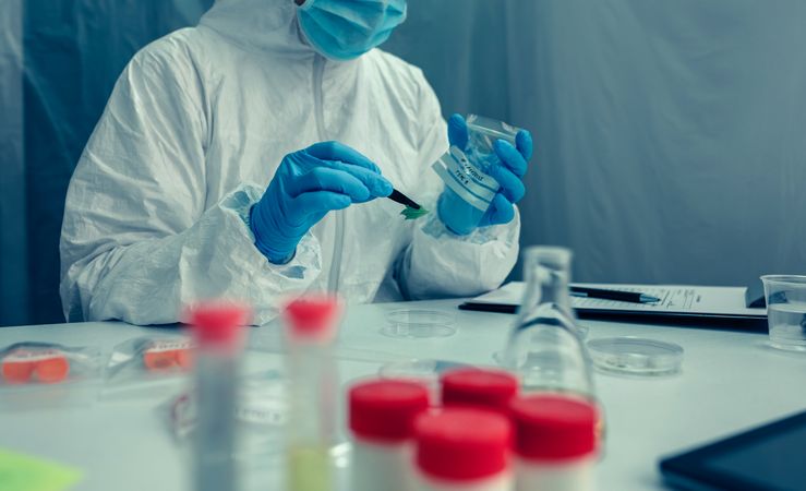 Scientist with protection suit doing research in the laboratory