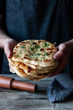 Crop man demonstrating naan bread