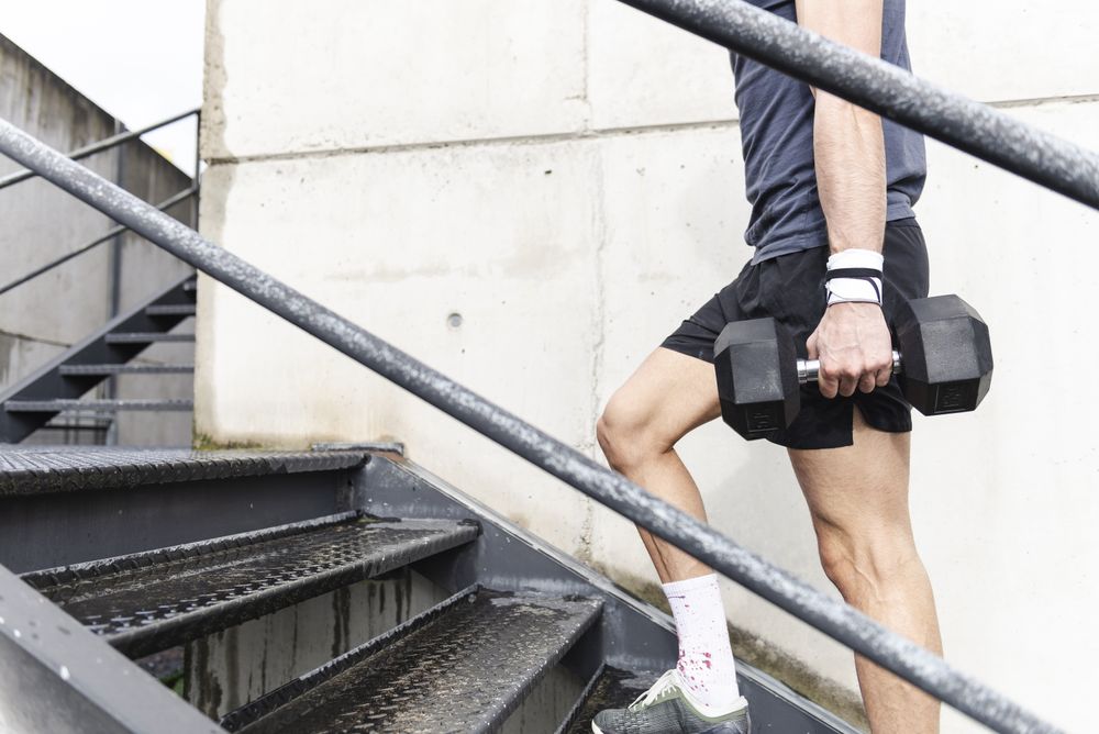Man training and going up on steps