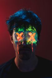 Male with covered eyes and neon face