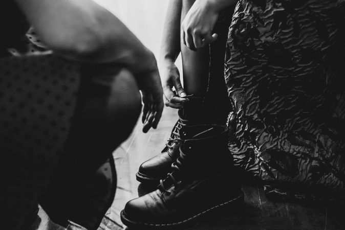 Woman in dress lacing boots