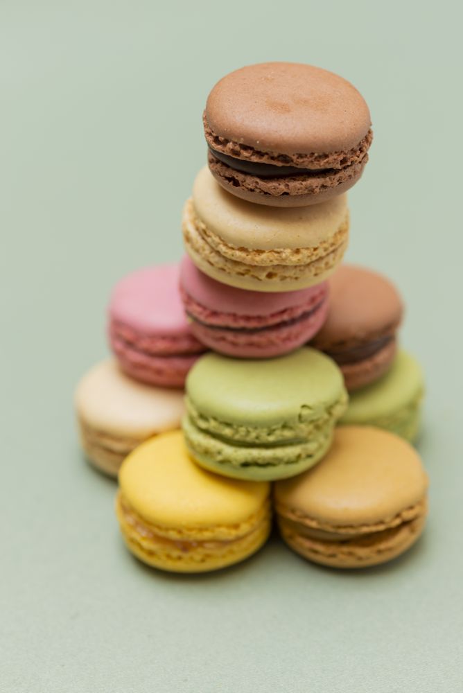 Colored tasty  macaroons on pile on a green background