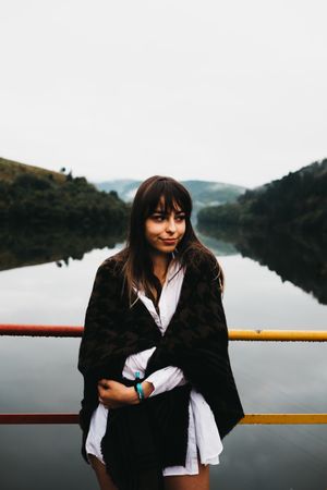 Woman standing looking amazing lake near mountains