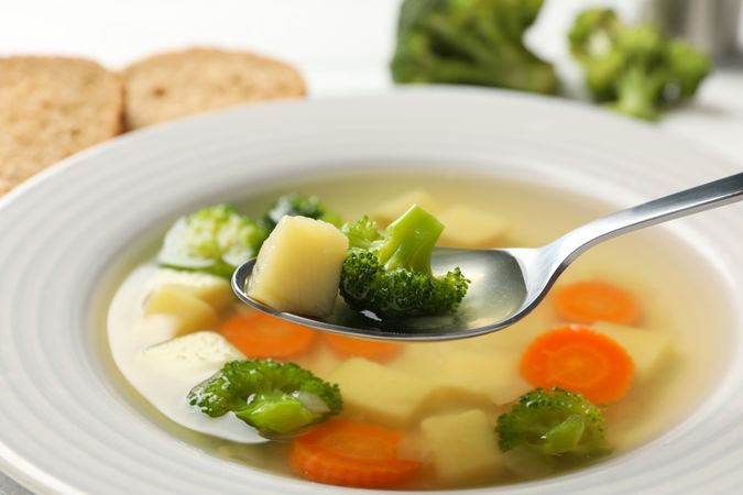 Bowl of vegetable soup with spoon