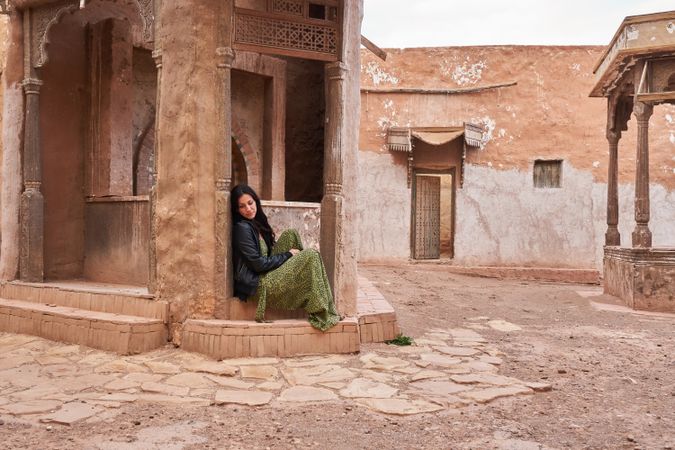 Woman on street between ancient buildings