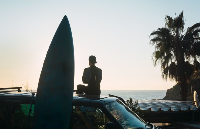 Man enjoying the sunrise in his camped van