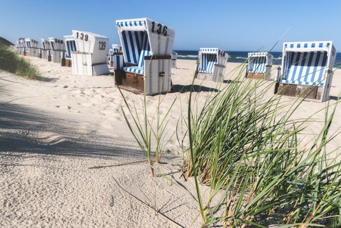 Beach scene with marram grass and defocused chairs on Sylt island