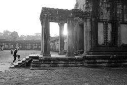 Man walking up the stairs at a temple in Angkor Wat, Cambodia