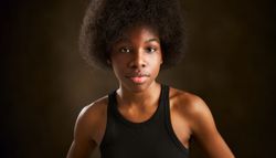 Portrait of a young Black woman with curly black afro