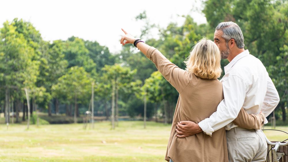Woman pointing at something in the sky with her partner