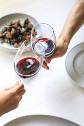 Couple cheering with red wine