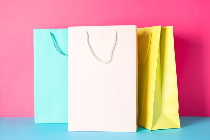 Color paper bags on multicolor background, space for text