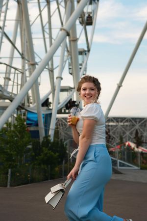 Woman near to ferris wheel