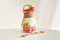Delicious yogurt dessert with pomegranate, kiwi, grape and ginger biscuit