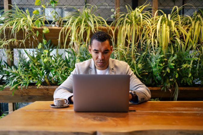 Man working on laptop at cafeteria