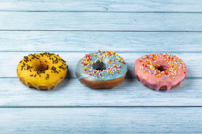 Delicious assorted colorful donuts on the table.