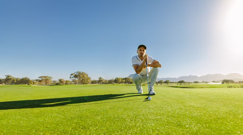 Young male in deep thought before golf shot