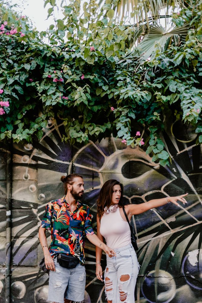 Casual friends against wall with graffiti
