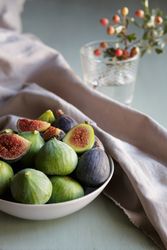 Plate of fresh ripe figs on kitchen table