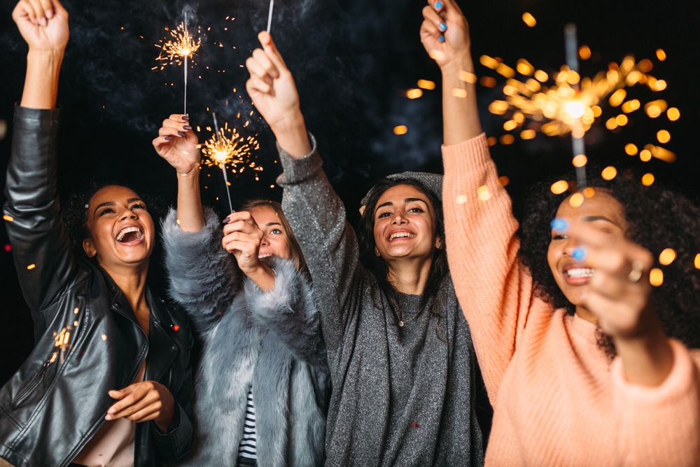 Multi-ethnic group of fun women celebrating at a party
