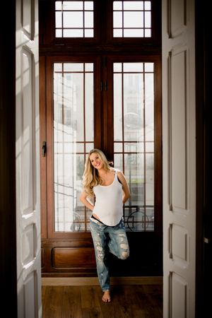 Pregnant female near open door