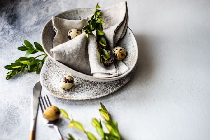 Easter card concept with elegant grey ceramic bowl and speckled eggs